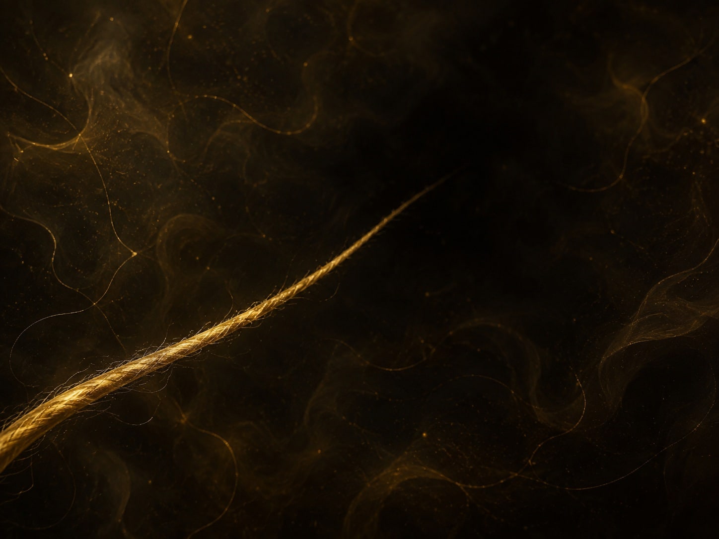 A thin gold thread extends partway across a hazy near-black space and fades into shadow.