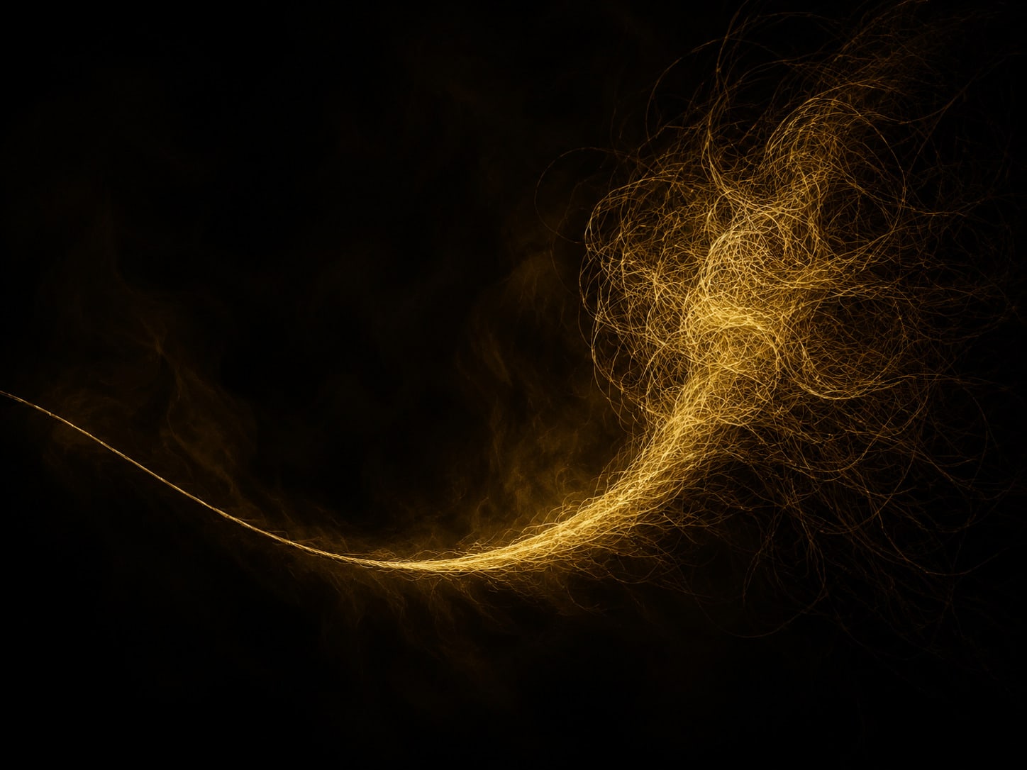 A thin gold filament thickening as it runs back into darkness, where it disappears into a large dense tangle of the same gold.